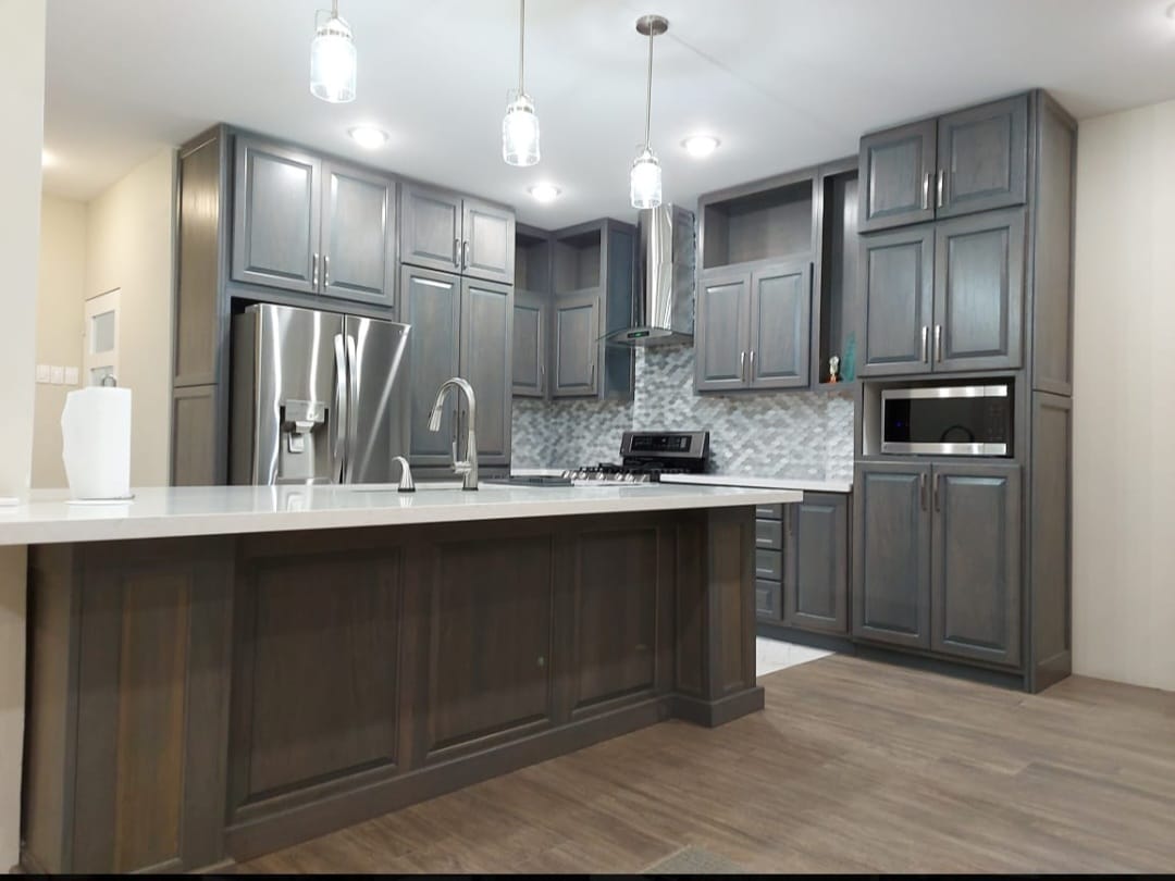 Full kitchen remodel with gray-stained cabinetry and island